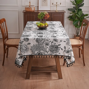French vintage linen tablecloth with black floral patterns and elegant fringe tassels