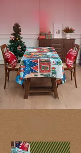Close-up of Christmas themed tablecloth with Santa, snow house, and pine tree patterns