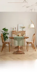 Detail of light green floral lace table runner on a rustic wooden dining table surface