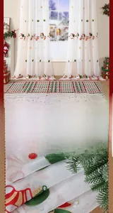Close-up of festive Christmas embroidery featuring Santa and snowflakes on white voile curtain