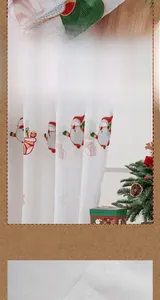 Detail of Christmas velvet curtain featuring embroidered Santa and snowflake patterns