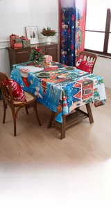 Blue Christmas tablecloth featuring festive Santa Claus and snow house prints for party decor