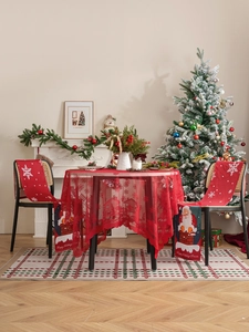 Close-up of red Christmas tablecloth lace with Santa Claus chimney chair cover detail