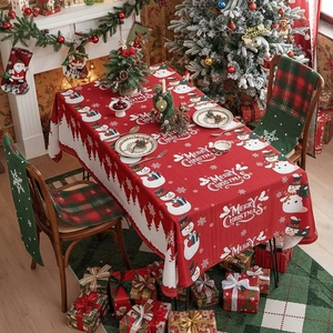 Christmas tablecloth with snowman print and red-green plaid chair covers for holiday decor