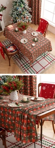 Close-up of red and green plaid Christmas tablecloth with white snowflake patterns