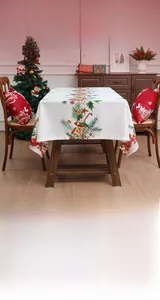 Detail of Christmas tablecloth with pine needles, bells, and candy cane festive patterns