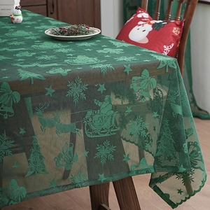 Green Christmas lace tablecloth featuring reindeer and Santa patterns for festive home decor