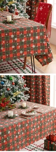 Detailed view of festive red and green plaid tablecloth with white snowflake patterns