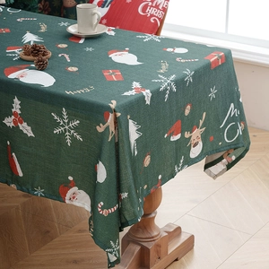 Deep green Christmas tablecloth with Santa and reindeer patterns on faux linen fabric