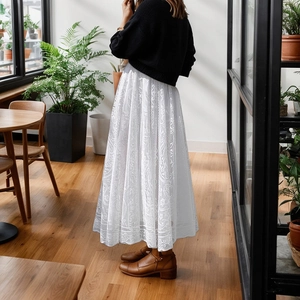 Elegant white crochet lace maxi skirt with floral hollow pattern for a bohemian summer look