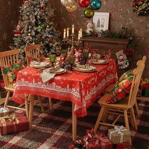 Red Christmas tablecloth with white European village pattern and festive wavy scalloped edges