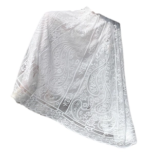 White lace fabric featuring paisley floral embroidery and delicate scalloped wave edges