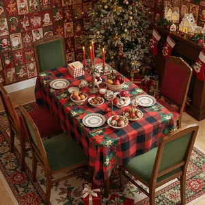 Classic red and black buffalo plaid Christmas tablecloth with poinsettia flower accents