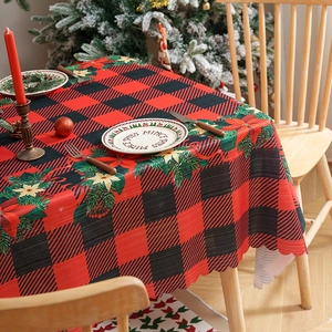 Festive red and black buffalo plaid Christmas tablecloth with poinsettia floral patterns
