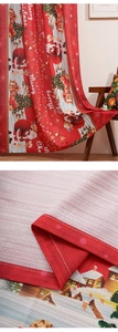 Close-up of woven fabric texture and stitching on red Santa Claus Christmas curtains