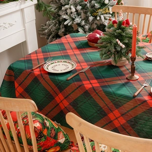 Red and green plaid Christmas tablecloth with matching holiday cushions for festive dining