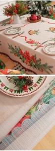 Detailed macro view showing the coarse woven texture and festive patterns of the Christmas tablecloth