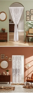 Detail of white French lace door curtain with floral embroidery and mesh texture