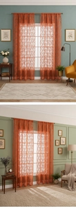Close-up of orange lace curtains with damascus patterns and scalloped wave edges