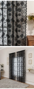 Detail of black lace curtain featuring delicate floral embroidery and scalloped wave edges