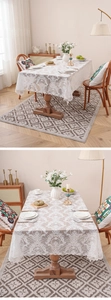 Close-up of white lace tablecloth with European floral patterns on dark wood table