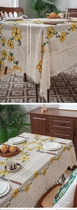 Detailed view of cream lace tablecloth with yellow flower embroidery and scalloped edges