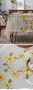 Detailed close-up of embroidered lace tablecloth with floral patterns and scalloped edges