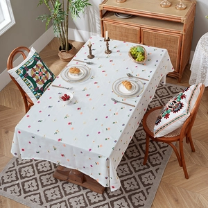 Floral embroidered white tablecloth and matching pillow set for dining room decor