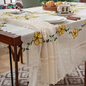 Cream lace tablecloth with yellow floral embroidery and elegant scalloped edges