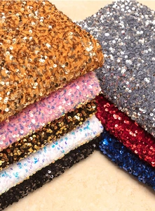 Macro shot of colorful high-density sequin fabrics for decorative Christmas hats