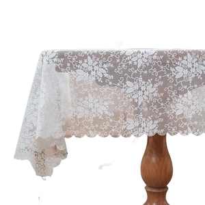 Elegant white lace tablecloth with floral hollow patterns and scalloped edges for home decor