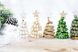 Detail view of five different wood bead and rope mini Christmas tree desk decorations