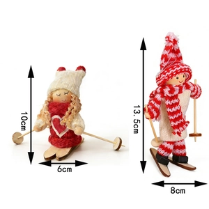 Detailed size view of two miniature wooden skiing dolls with knitted hats for Christmas