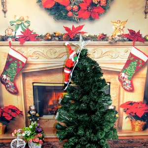 Detail of 25cm climbing Santa Claus ornament on ladder next to a glowing Christmas tree