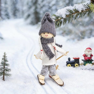 Christmas wooden skiing girl doll figurine with grey hat and skis in snow forest