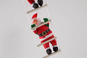 Detailed view of three Santa Claus figures climbing a white rope ladder for Christmas decor