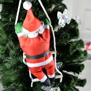 Detail of 25cm Santa Claus climbing a rope ladder hanging on a green Christmas tree