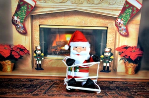 Close-up of Santa Claus climbing a rope decoration by a festive fireplace setting