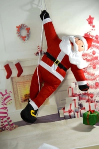 Climbing Santa Claus ornament hanging on rope with green gift box for Christmas tree decor