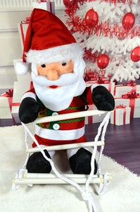 Close-up of Santa Claus climbing ladder with reindeer embroidery and button detail