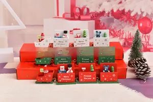Three colorful wooden Christmas trains with Santa and snowmen on festive red gift boxes