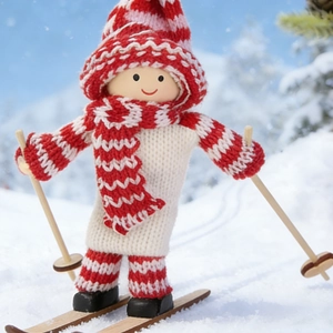 Handcrafted wooden skiing doll wearing red striped knit hat on snowy background