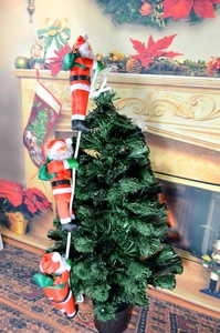 Detail of three small Santa figures climbing a white rope for Christmas tree decor