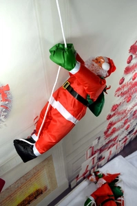 Père Noël de 50cm grimpant une échelle de corde blanche avec sac de cadeaux