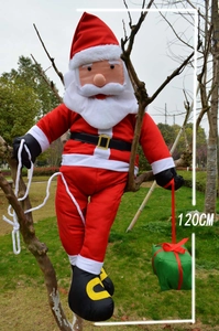 Detailed 120cm climbing Santa Claus ornament hanging from a tree with a green gift box