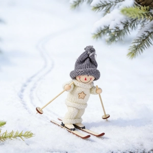 Detailed view of a wooden skiing doll ornament with knit outfit in outdoor snow scenery