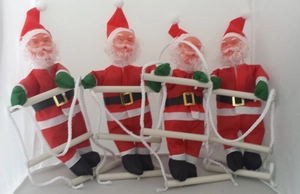 Detailed view of four 25cm Santa Claus dolls climbing a white rope ladder decoration