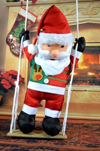 Detail of plush Santa Claus sitting on a wooden swing with festive reindeer outfit