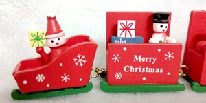 Close-up of 4-section wooden Christmas train with Santa, snowman and festive elements