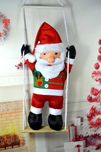 Charming Santa Claus on a wooden swing hanging decoration for festive holiday home decor